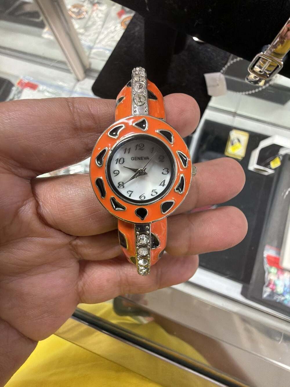Geneva Women's Hinged Bangle Watch with Orange Enamel and Rhinestone Accents